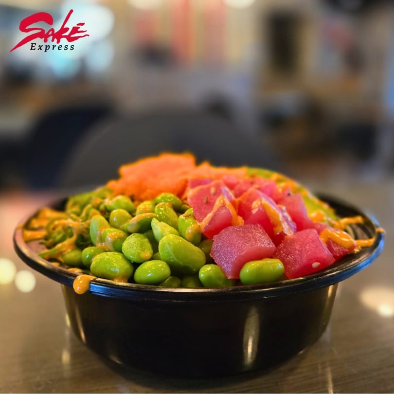 Sake Express poke bowl with tuna, edamame, and orange roe, drizzled with sauce.